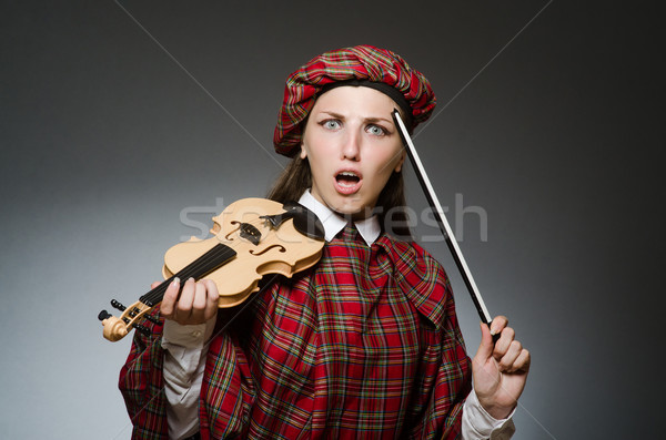 Woman in scottish clothing in musical concept Stock photo © Elnur