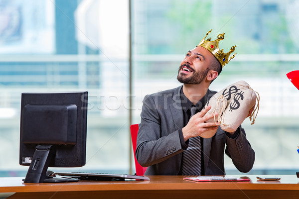Businessman with crown and money sacks in the office Stock photo © Elnur