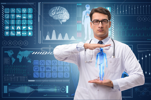 Doctor in futuristic medical concept pressing button Stock photo © Elnur