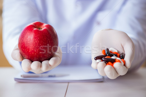 Doctor offering the choice between healthy and vitamins Stock photo © Elnur