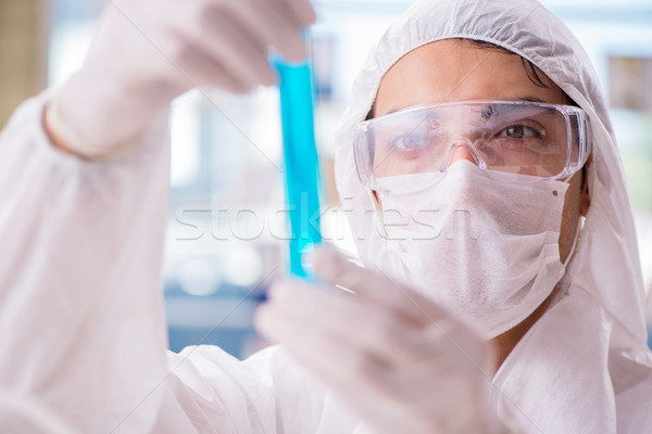 Chemist working in the laboratory with hazardous chemicals Stock photo © Elnur