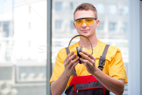 Young construction worker in yellow coveralls Stock photo © Elnur