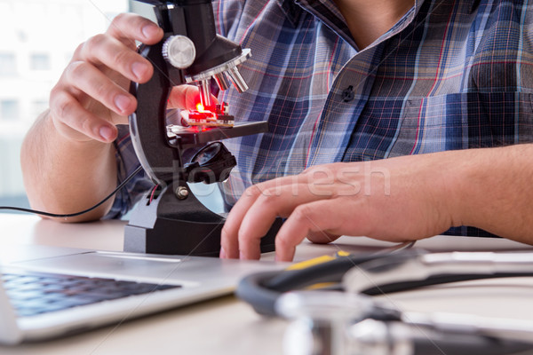 High precision engineering with man working with microscope Stock photo © Elnur