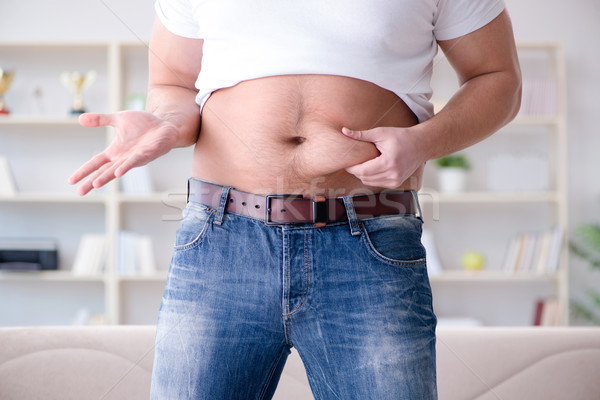 Man suffering from extra weight in diet concept Stock photo © Elnur