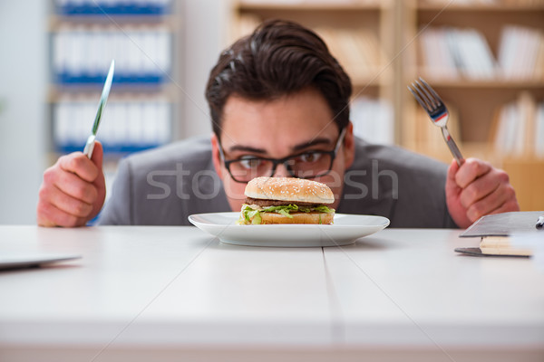 Hungry funny businessman eating junk food sandwich Stock photo © Elnur