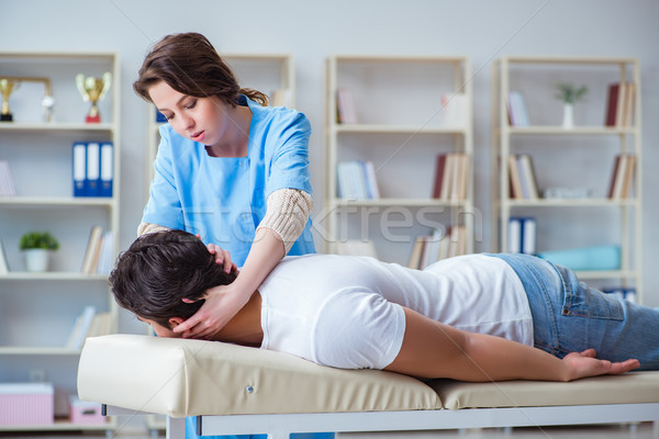 Female chiropractor doctor massaging male patient Stock photo © Elnur