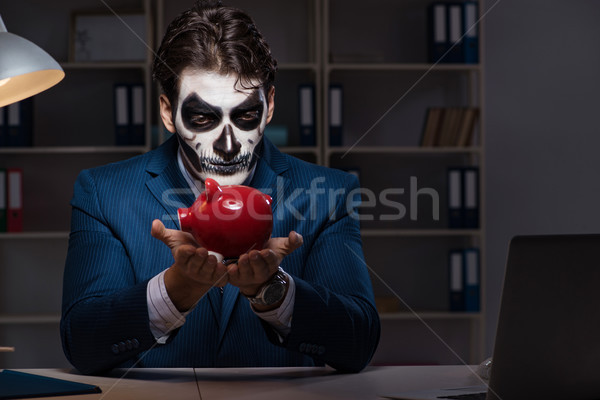 Businessman with scary face mask working late in office Stock photo © Elnur