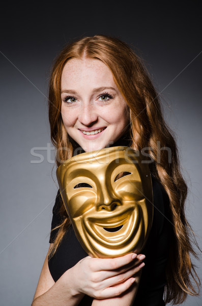 Redhead woman iwith mask in hypocrisy consept against grey backg Stock photo © Elnur