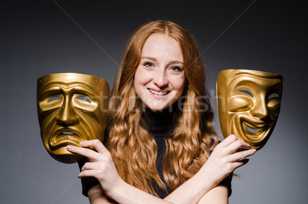 Redhead woman iwith masks in hypocrisy consept against grey back Stock photo © Elnur