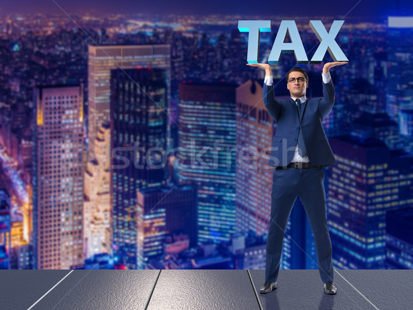 Stock photo: The man under the burden of tax payments
