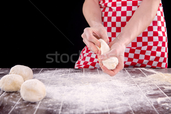 Cook preparing dough for baking in the kitchen Stock photo © Elnur