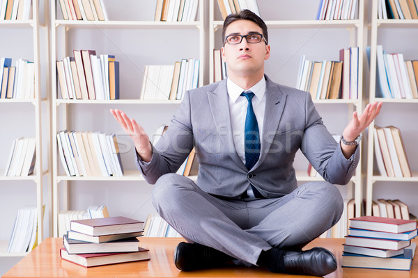 Businessman student in lotus position concentrating  in the libr Stock photo © Elnur