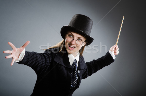Stock photo: Harry Potter girl with magic stick against gray