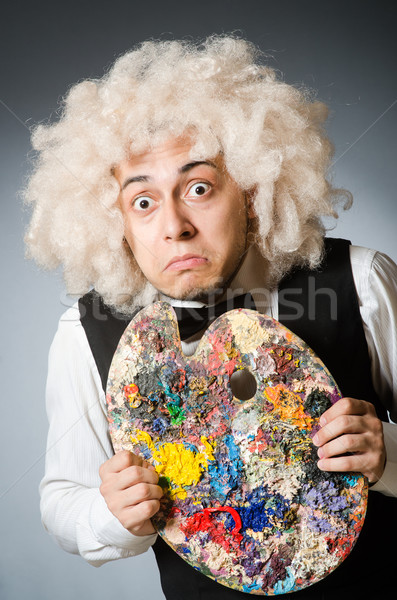 Funny artist in dark studio Stock photo © Elnur