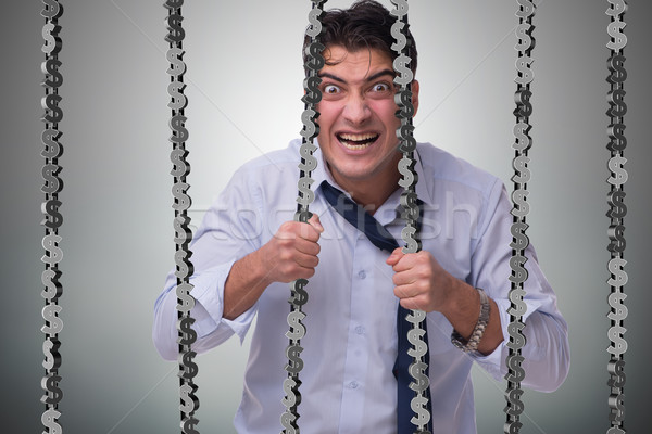 Stock photo: Man trapped in prison with dollars