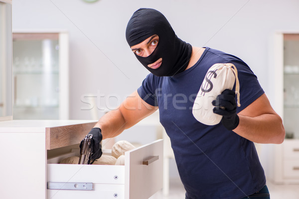 Robber wearing balaclava stealing valuable things Stock photo © Elnur