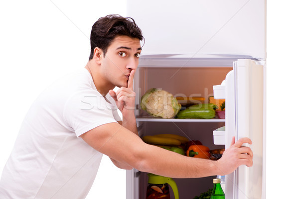 Man next to fridge full of food Stock photo © Elnur