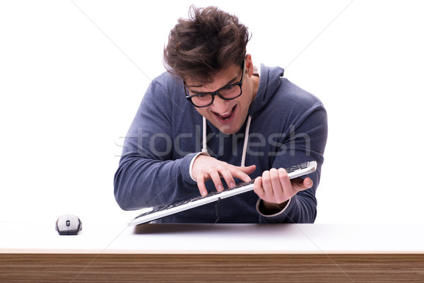 Stock photo: Funny nerd man working on computer isolated on white