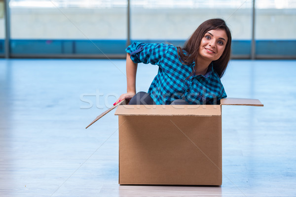 Young woman with box in moving house concept Stock photo © Elnur