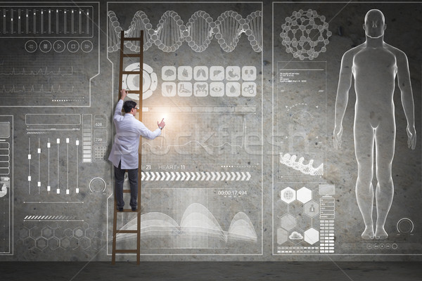 Stock photo: The male doctor climbing ladder in medical concept