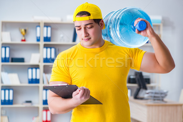 Stock photo: The man delivering water bottle to the office