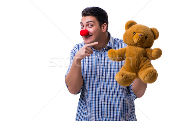 Stock photo: Funny clown man with a soft teddy bear toy isolated on white bac