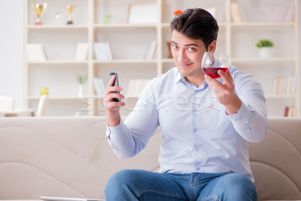 Stock photo: Young man chatting with his sweetheart over mobile phone