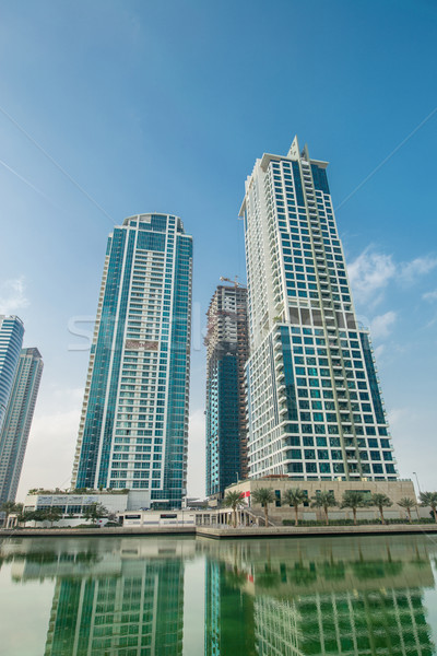 Tall skyscrapers in Dubai near water Stock photo © Elnur
