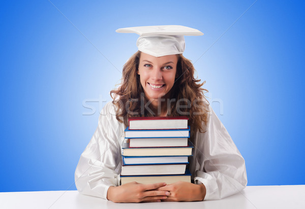 Happy graduate with lots of books on white Stock photo © Elnur
