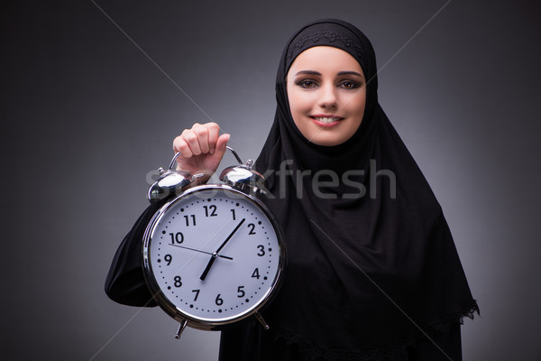 Muslim woman in black dress against dark background Stock photo © Elnur