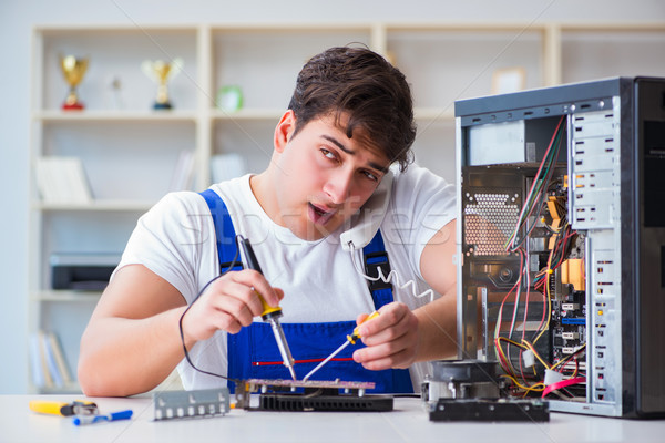 Computer repairman repairing desktop computer Stock photo © Elnur