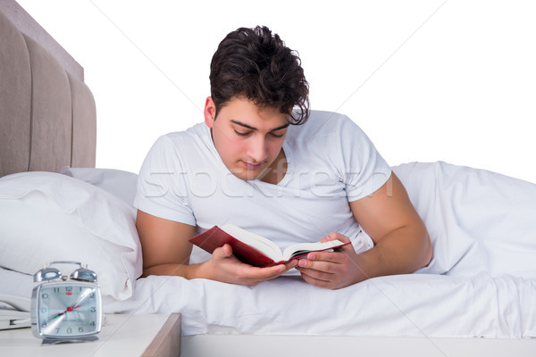 Hombre cama sufrimiento insomnio libro reloj Foto stock © Elnur
