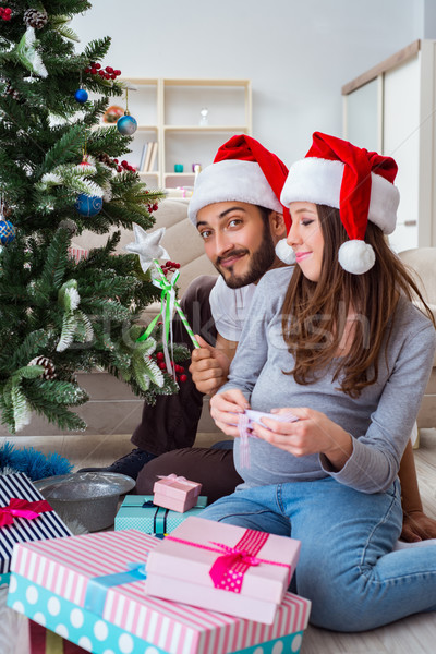 The young family expecting child baby celebrating christmas Stock photo © Elnur
