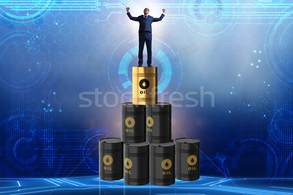 Businessman on top of oil barrels Stock photo © Elnur