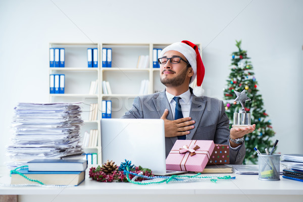 Young businessman celebrating christmas in the office Stock photo © Elnur