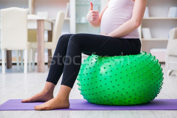 Pregnant woman exercising in anticipation of child birth Stock photo © Elnur