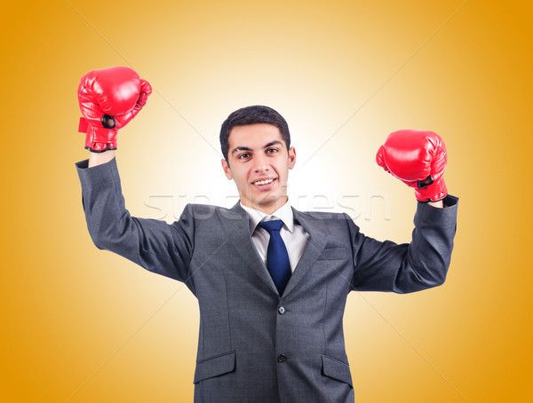 Young businessman with boxing gloves Stock photo © Elnur
