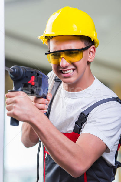 Man drilling the wall with drill perforator Stock photo © Elnur