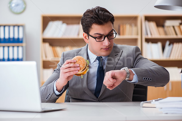 Hungry funny businessman eating junk food sandwich Stock photo © Elnur