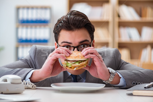 Hambriento funny empresario comer sándwich Foto stock © Elnur