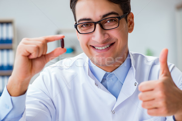Stock photo: Doctor holding medicines in the lab