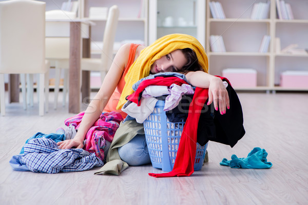 Stressed woman doing laundry at home Stock photo © Elnur