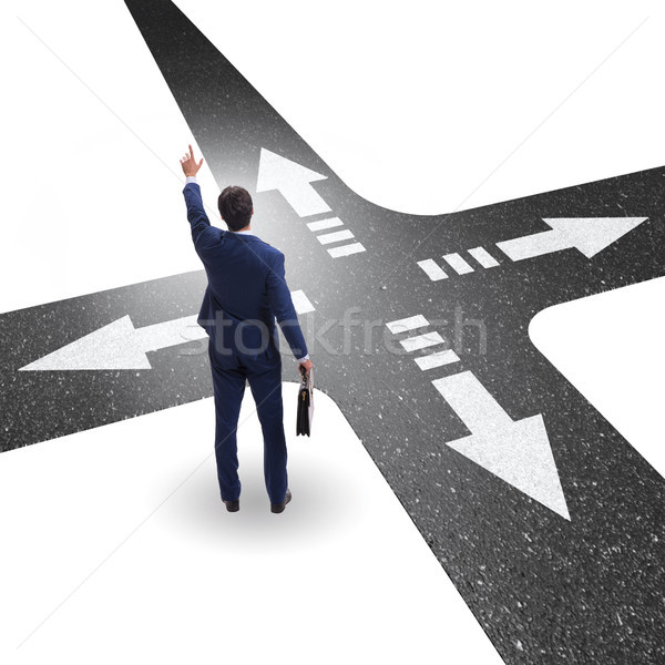 Young businessman at crossroads in uncertainty concept Stock photo © Elnur
