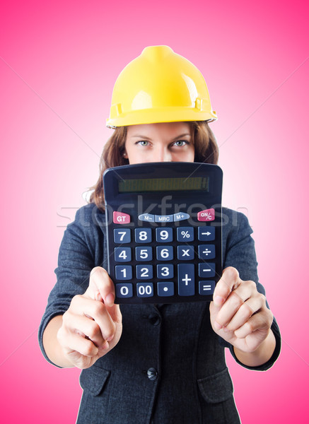 Female builder with calculator against gradient  Stock photo © Elnur