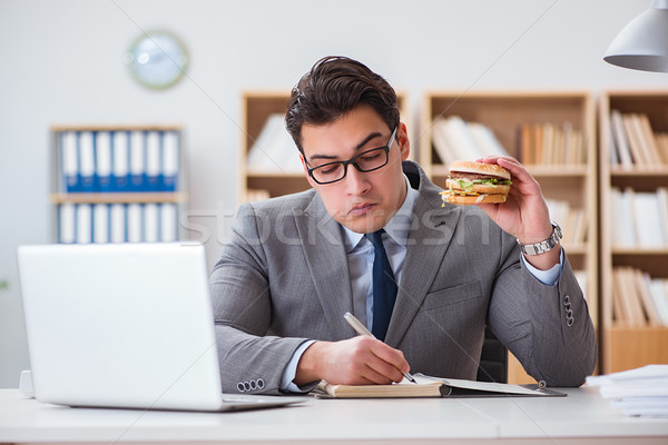 Stock photo: Hungry funny businessman eating junk food sandwich