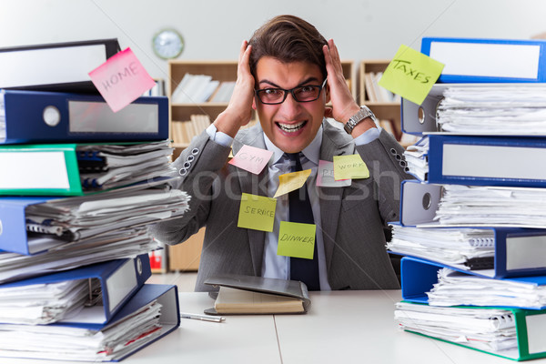 Businessman struggling with multiple priorities Stock photo © Elnur