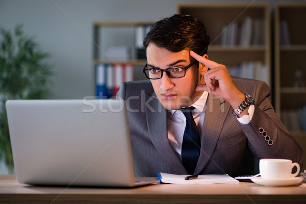 Businessman staying in the office for long hours Stock photo © Elnur