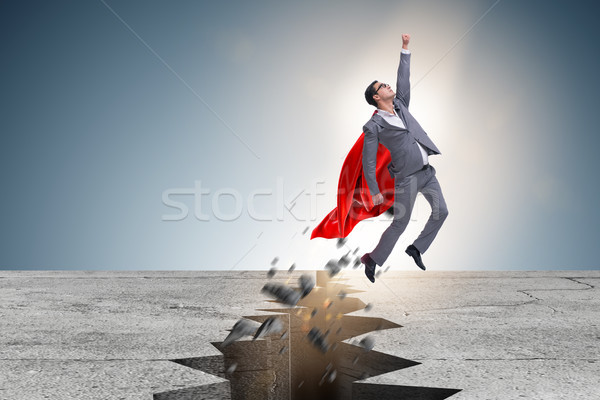 Stock photo: Superhero businessman escaping from difficult situation