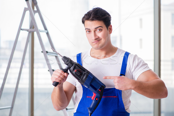 Young worker with hand drill Stock photo © Elnur
