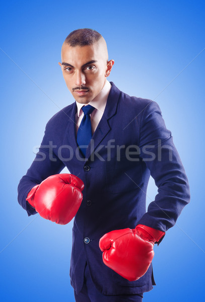 Handsome businessman with boxing gloves Stock photo © Elnur